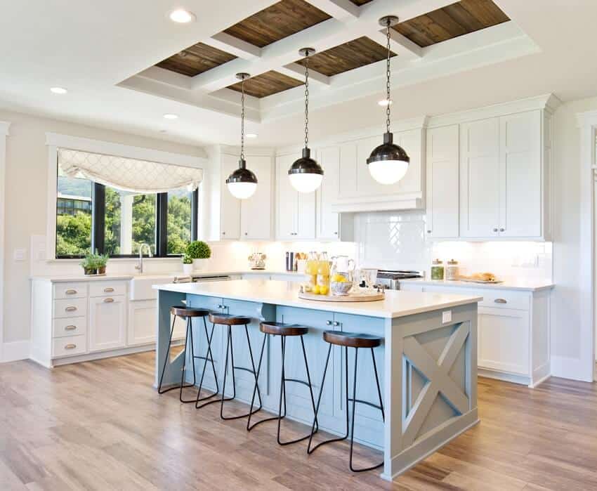 White gourmet kitchen with farmhouse sink and kitchen island with cutting board and citrus lemon on it