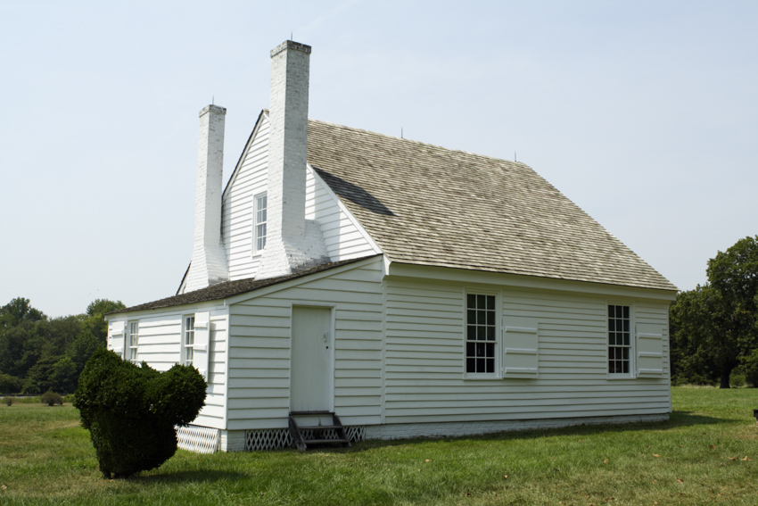 White house exterior with clapboard siding chimneys windows