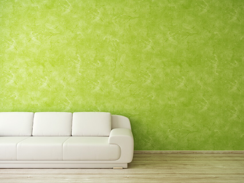 White leather sofa on green venetian wall texture type background