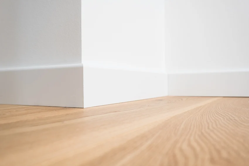Wood floor baseboard white color same as wall