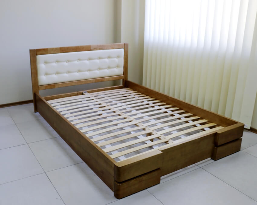 Wooden bed frame with cut slats