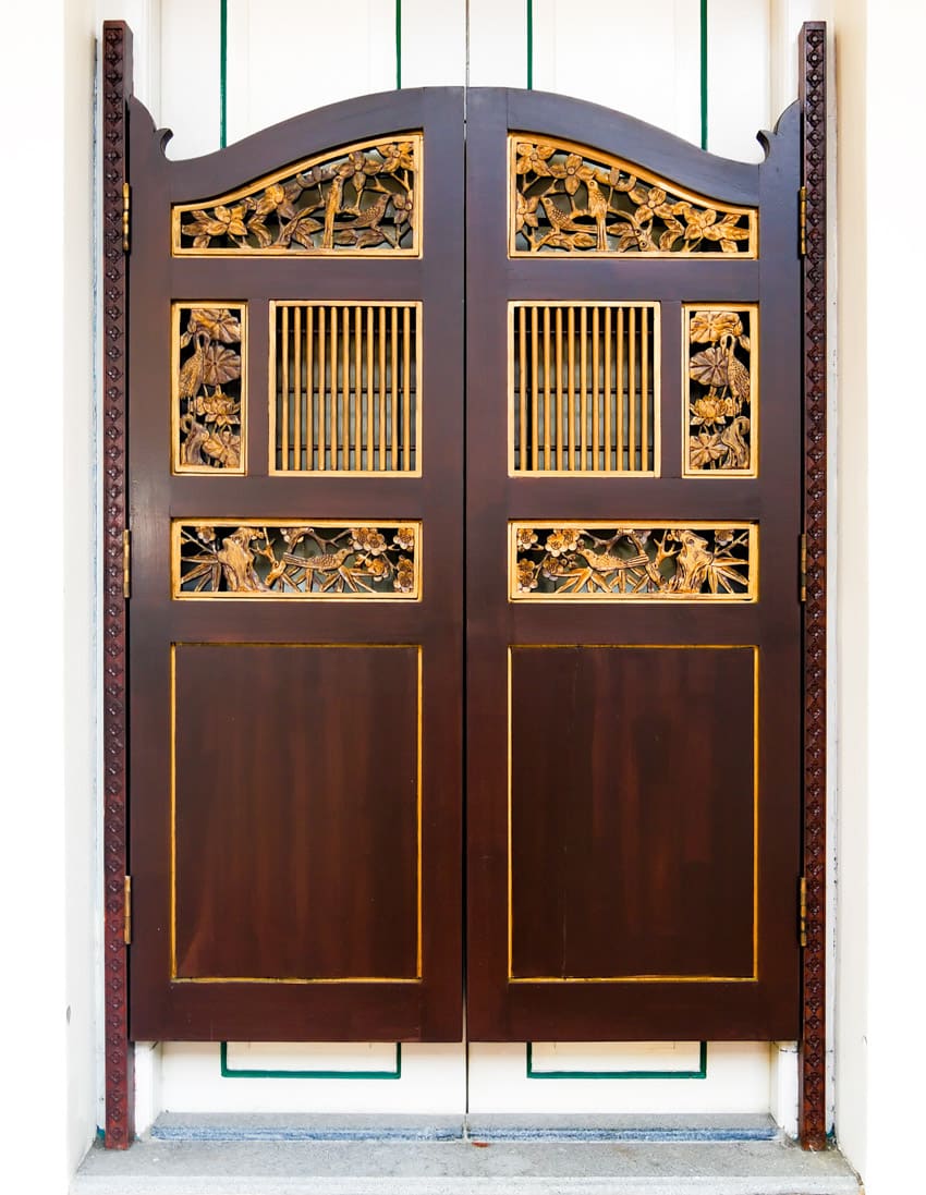 Wooden crafstman saloon door with an ornate design