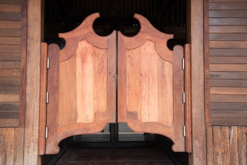 Wooden saloon doors with a batwing design