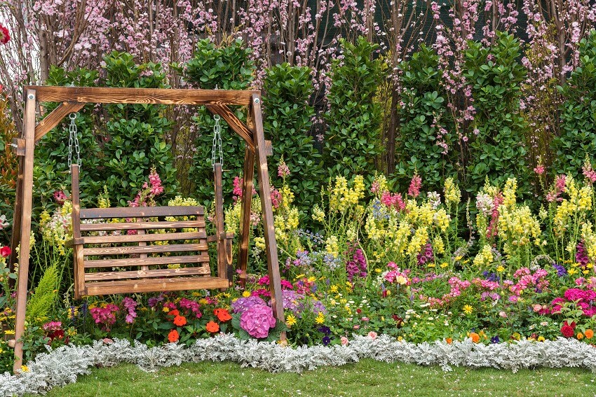 Wooden swing seat with flowers everywhere
