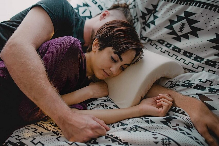 Couple with cuddling pillow