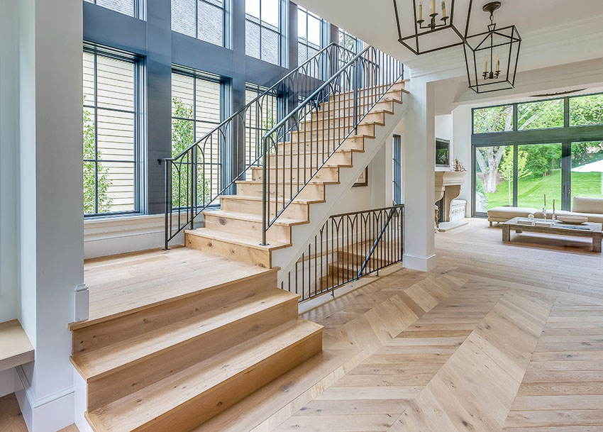 House stairs with metal railings wooden floor picture windows