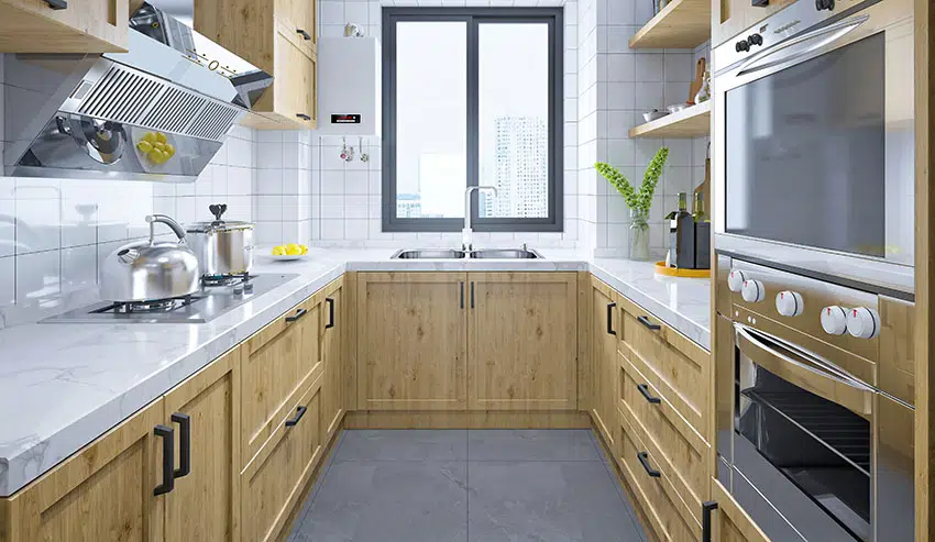 Kitchen with white marble countertops, subway tile backsplash and cabinets with black handles