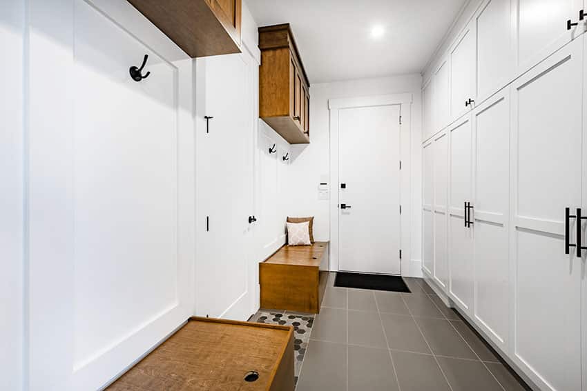 Mudroom with benches lockers hanging cabinets white paint