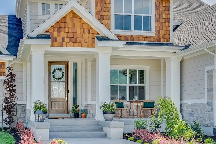 A home with natural wood siding, and stone exterior