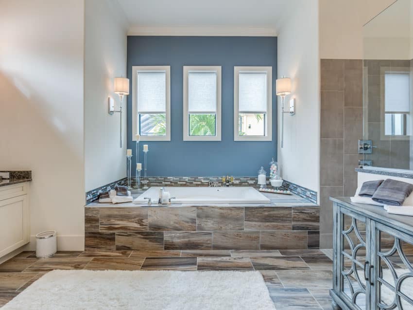 Beautiful bathroom space blue wall drop in tub tiles
