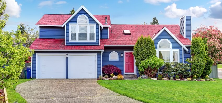 Beautiful curb appeal with blue exterior paint and red roof