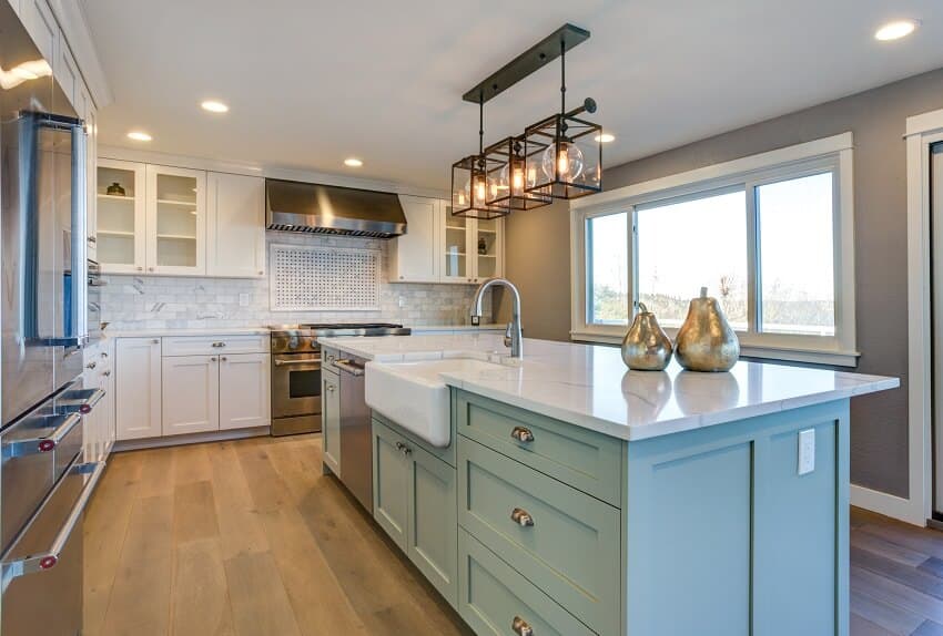 Beautiful kitchen room with green island farmhouse sink and wood flooring