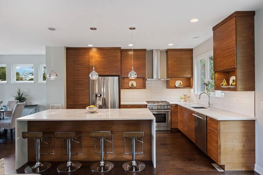 Beautiful kitchen with center island zebrawood kitchen cabinets stools countertop hood windows wood flooring