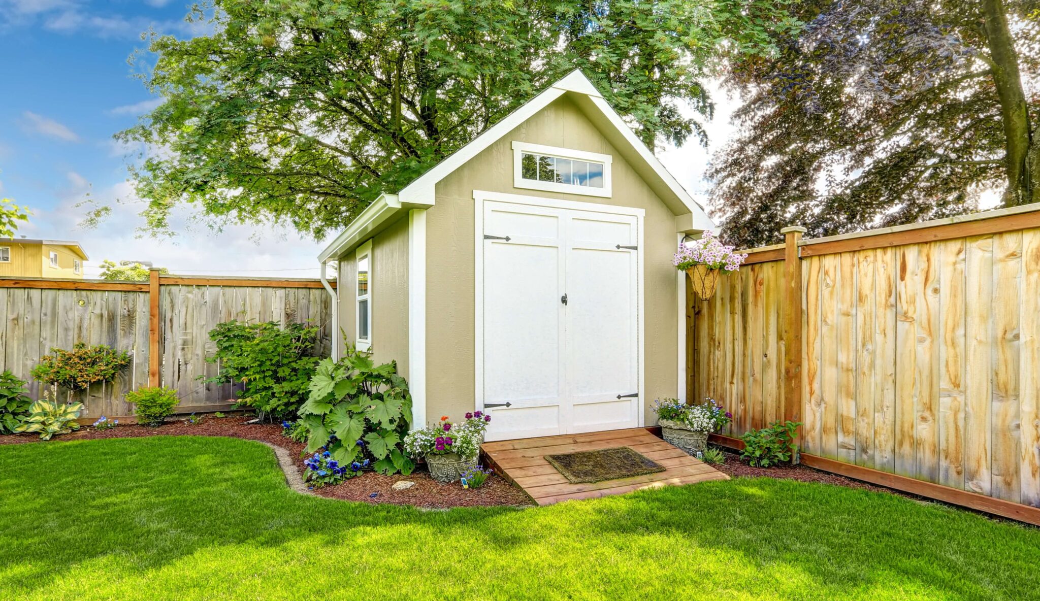 Beautiful new shed with flower bed on backyard area 