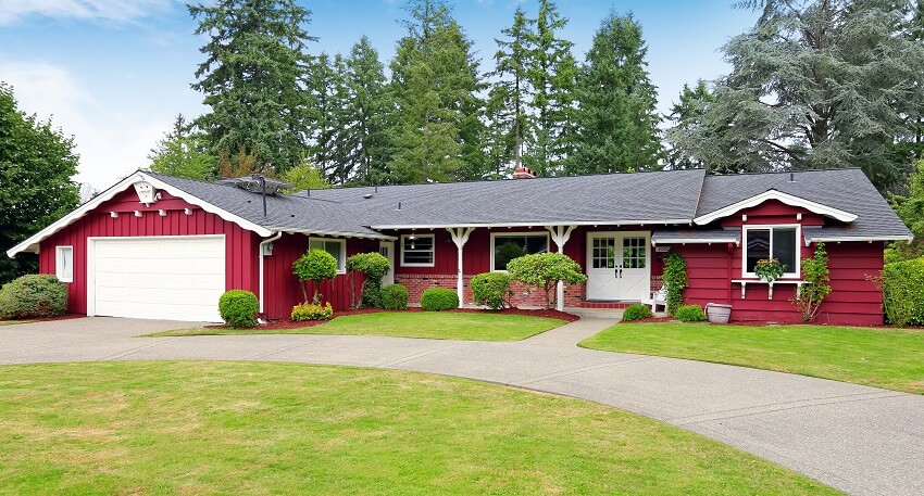 Beautiful red house with huge green lawn entrance porch walkway and garage with driveway