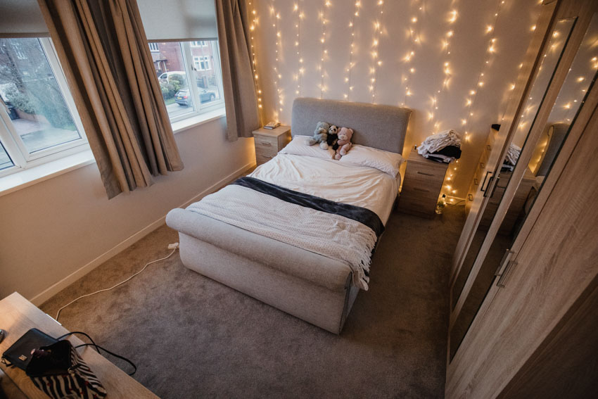 Bedroom with creative wall covering rug windows cabinets