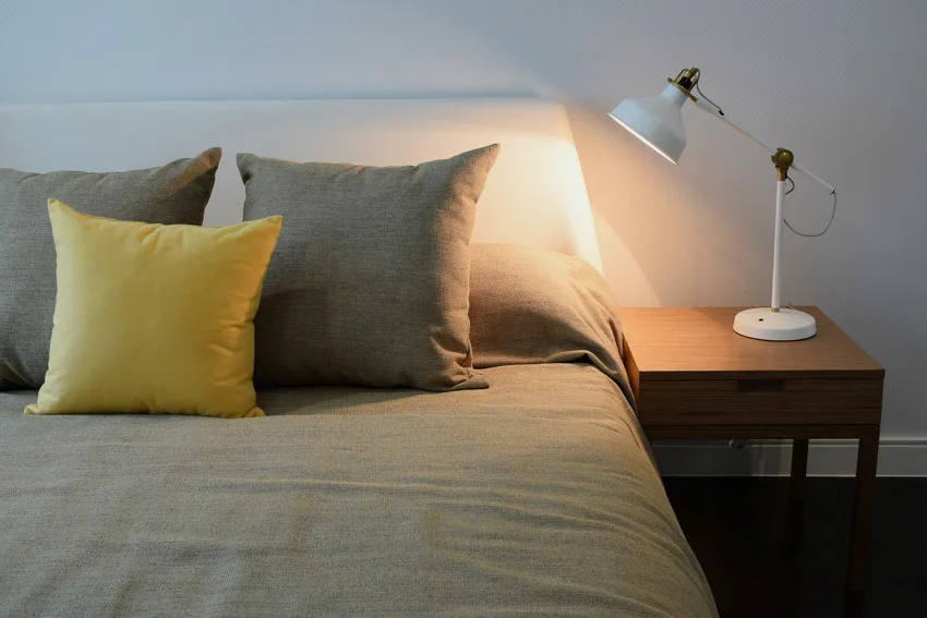 Bedroom with pillows cushion headboard nightstand lamp