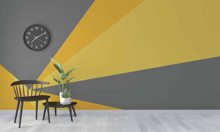 Black and yellow geometric wall clock chair indoor plant wood floor