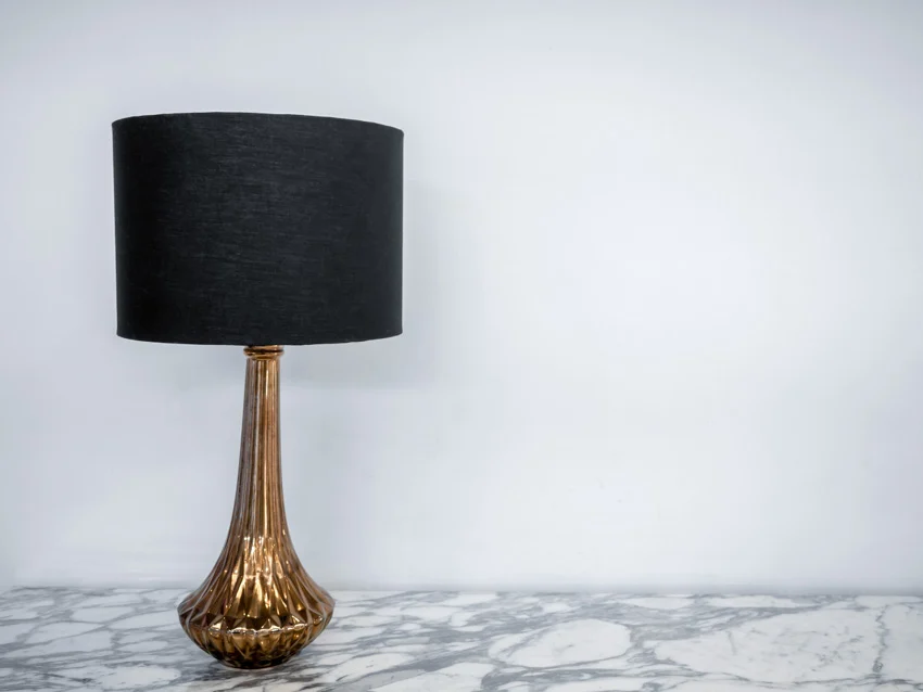 Black fabric lamp shade on marble surface