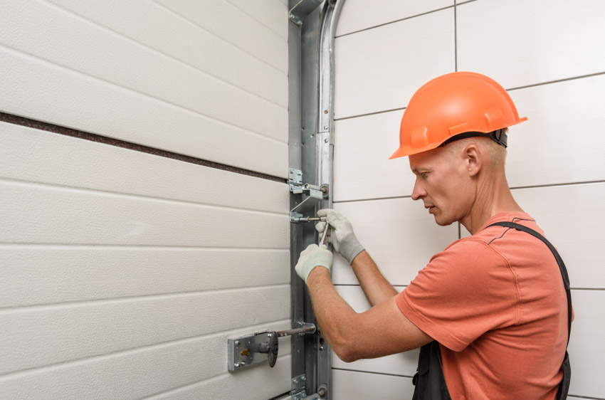 Contractor installing trackless design garage doors