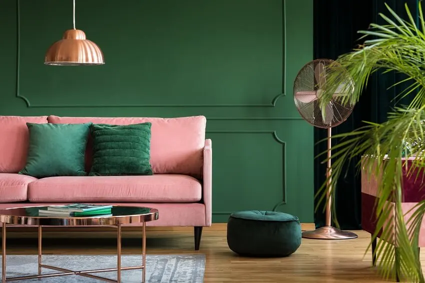 Copper lamp and table in a green living room interior