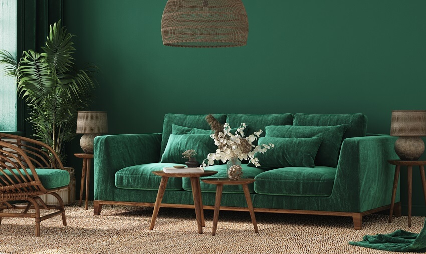Cozy green home interior with green sofa table and decor in living room