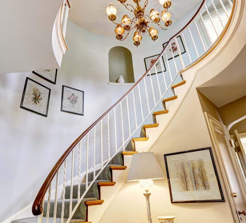 Curving staircase wall picture frames chandelier