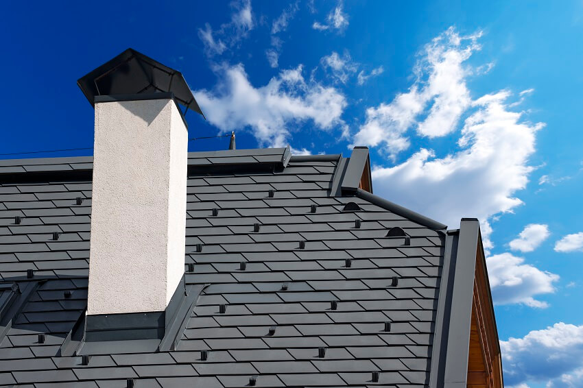 Detail of modern metallic roof with white chimney