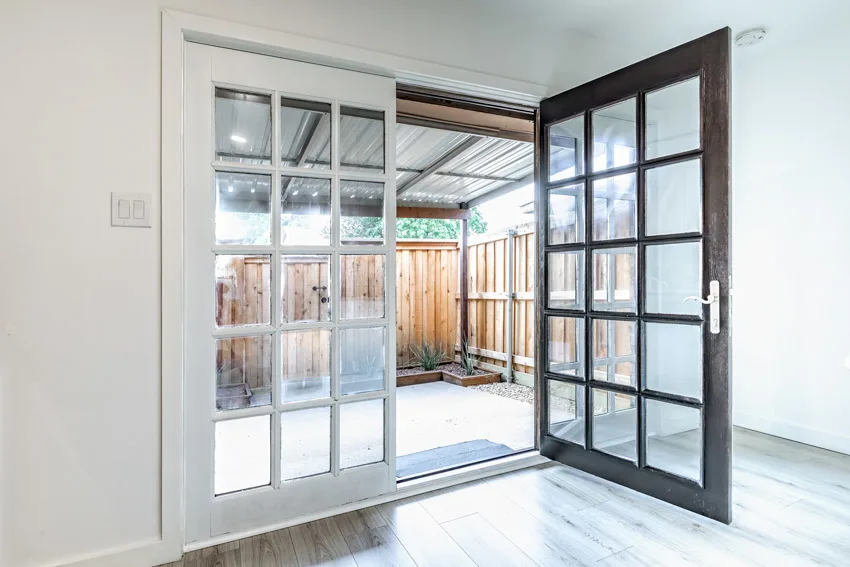 Double French doors and light wood flooring