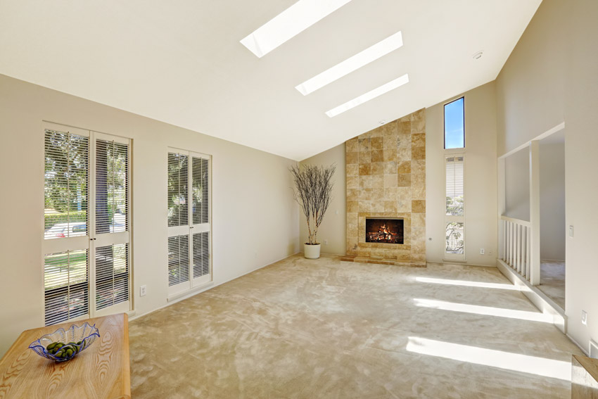 Empty room with linoleum floor windows fireplace white walls