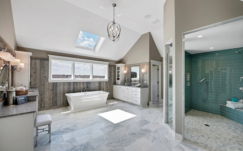 Ensuite bathroom with green walk in shower free standing tub lighting fixtures cabinets and tile floors