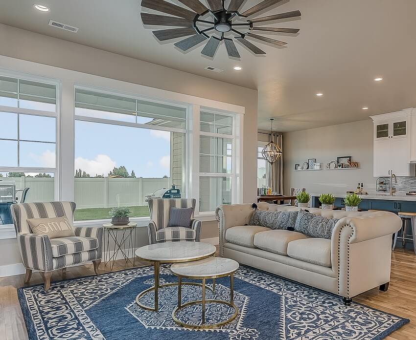 Farmhouse style ceiling fan and decorative rug in front family room