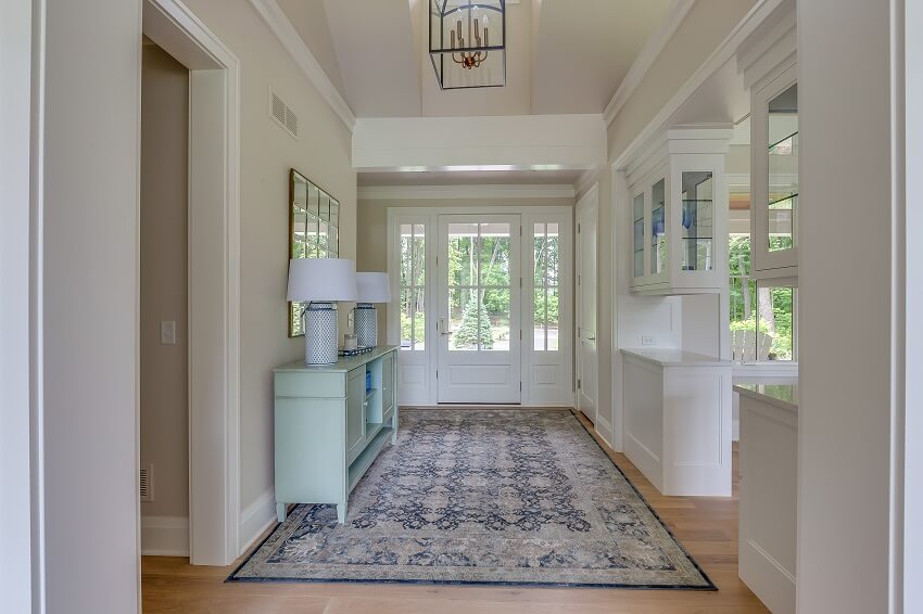 Front entry of a home with rug console table and lamps