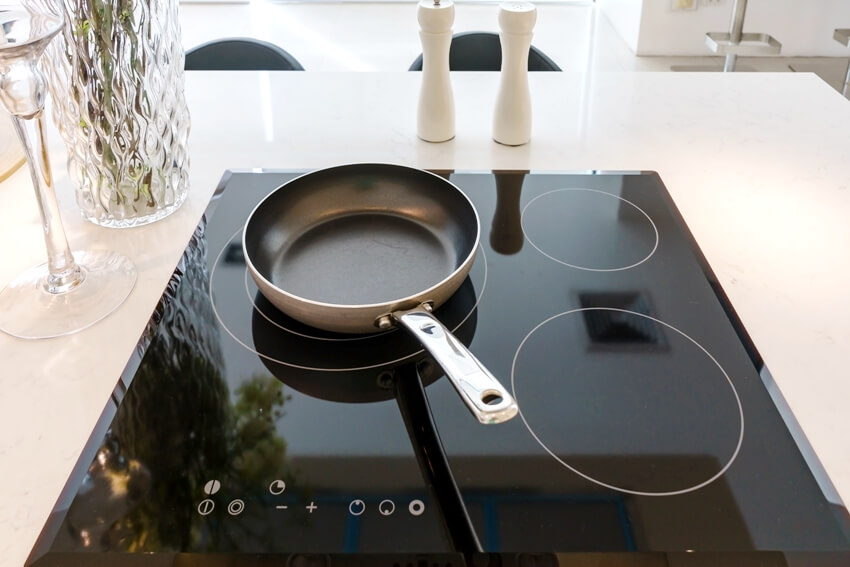 Frying pan on modern black induction stove