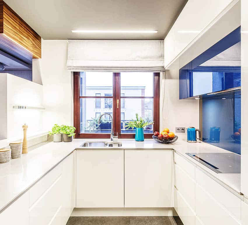 Galley kitchen with linear ceiling light fixture