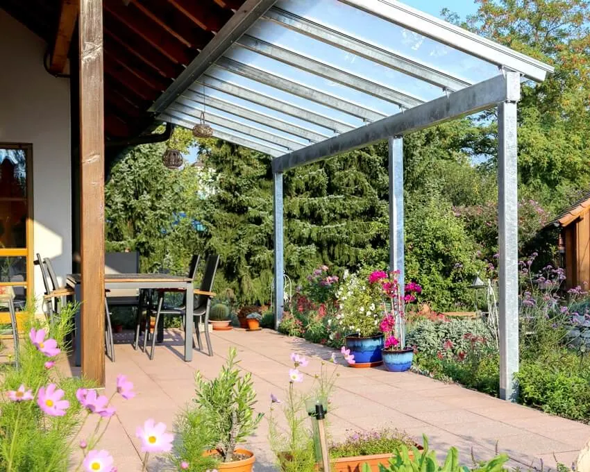 Glass patio with attached cover and a view of the garden