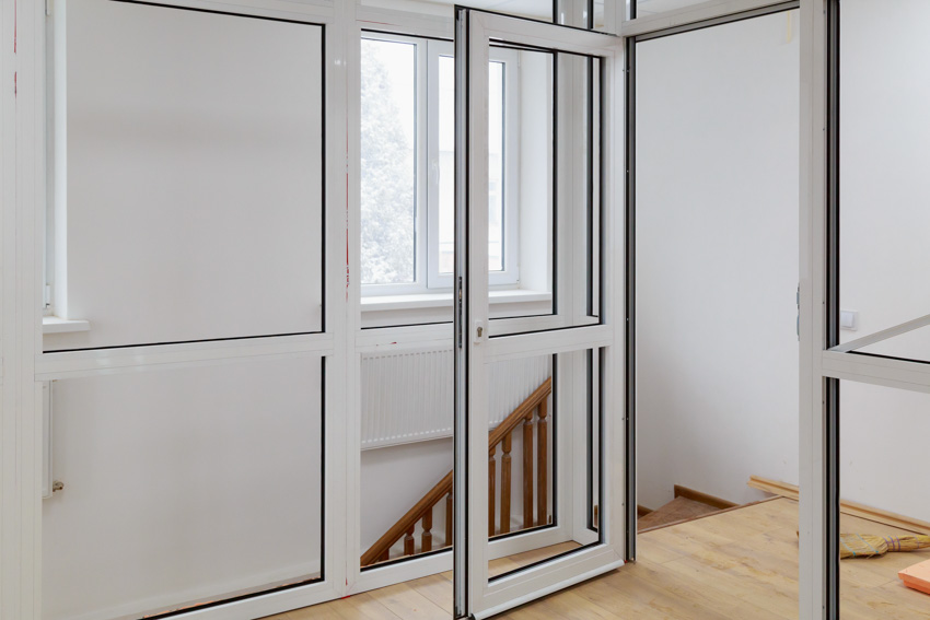 Glass pivot door wood floor windows stairs