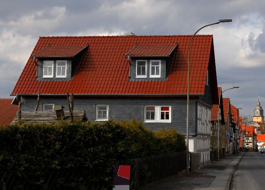 Gray house with red roof in a residential area