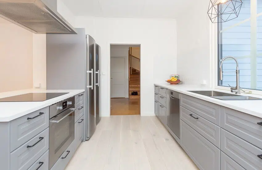 Grey kitchen interior with open door to the hallway