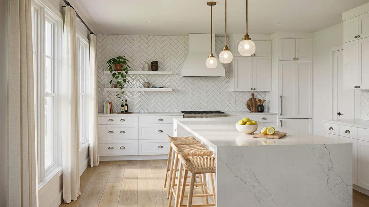 Herringbone subway tile in beautiful white cabinet kitchen with waterfall quartz island
