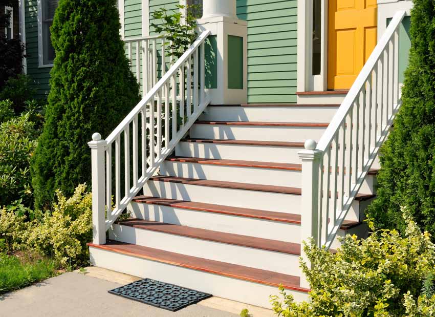 House exterior with stairs painted railings white siding