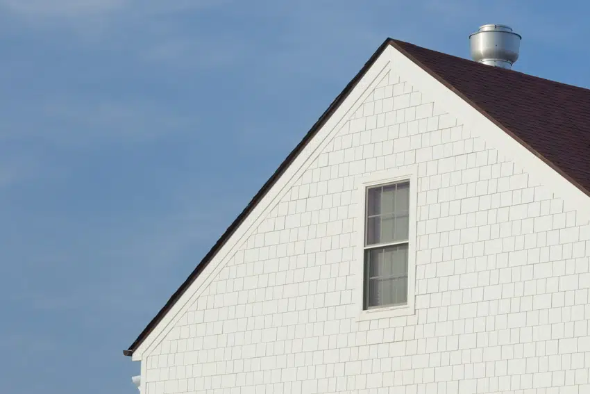 House exterior with white shaker vinyl siding glass window