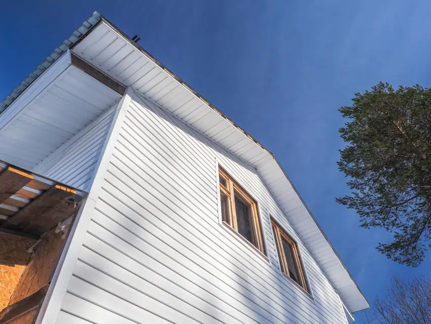 House exterior with white vinyl siding wood windows
