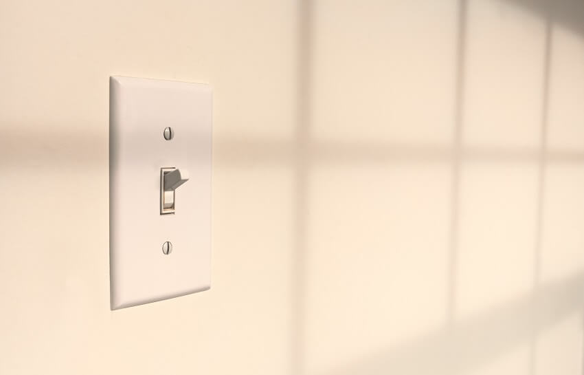 Interior toggle light switch on white wall