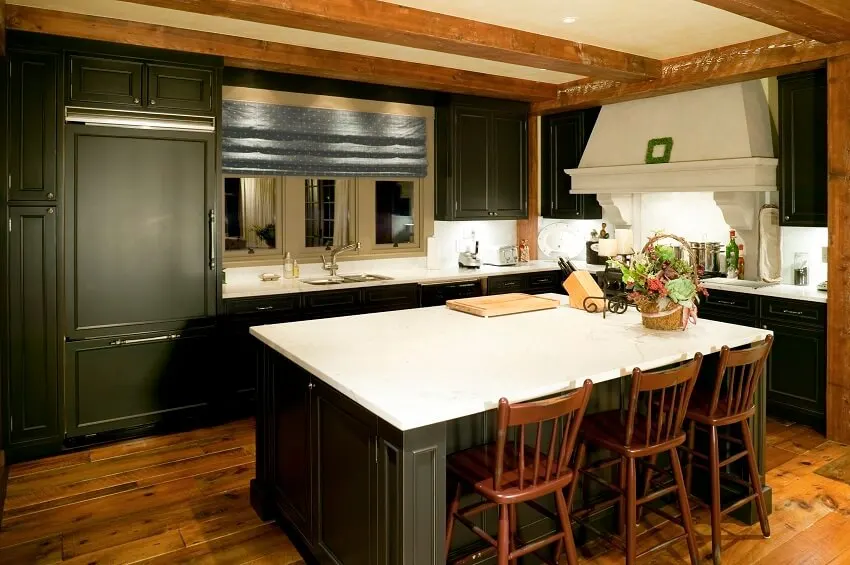 Kitchen area with hardwood floors bar stools black cabinets & island white countertops and post and beam