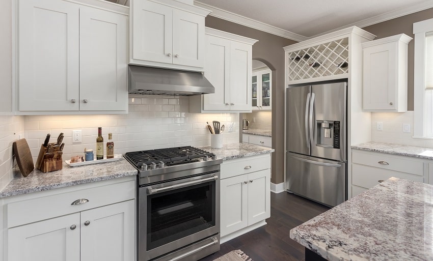 Kitchen in new luxury home with island stainless steel appliances and hardwood floors
