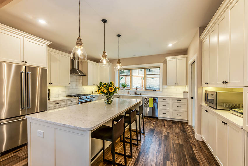 Kitchen off white cabinets beige wall paint marble countertops pendant lighting