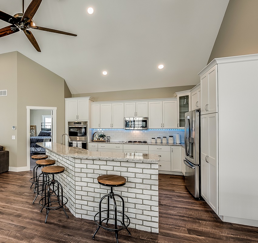 kitchen-with-ceiling-fan-recessed-lights-white-cabinets-and-subway-tile-on-kitchen-island-is