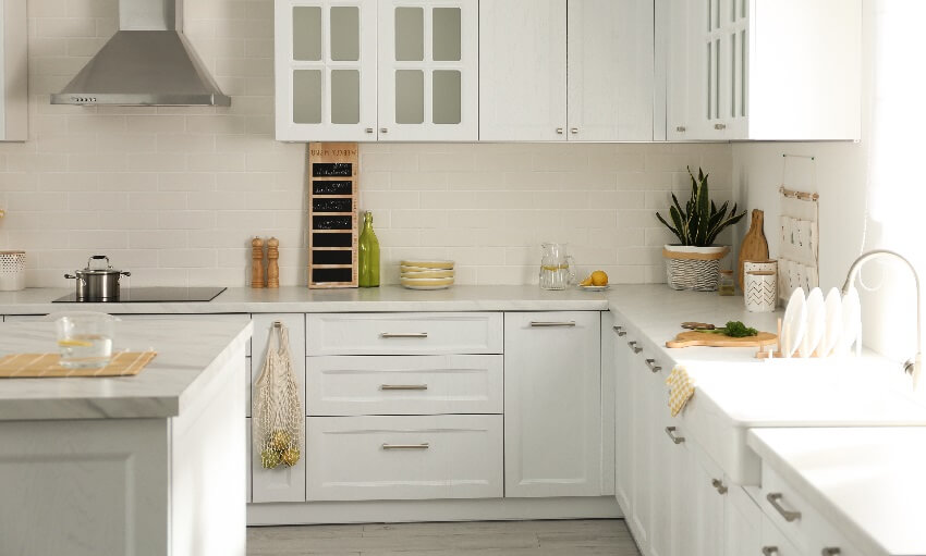 Kitchen with composite marble countertops white cabinets and drawers