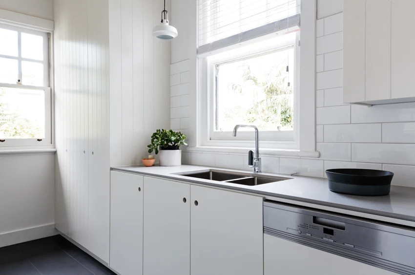 Kitchen with white cabinets vinyl windows sink stove